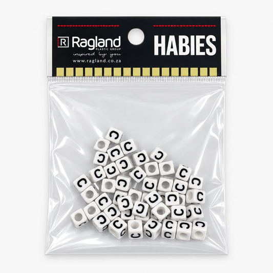 A clear plastic zip-top bag containing many small white cube beads printed with a black letter C, attached to a black Ragland brand header card that reads HABIES.
