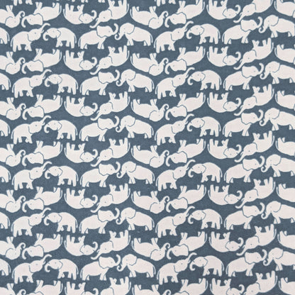 A close-up of a fabric pattern featuring repeating white elephant silhouettes on a muted slate blue background.