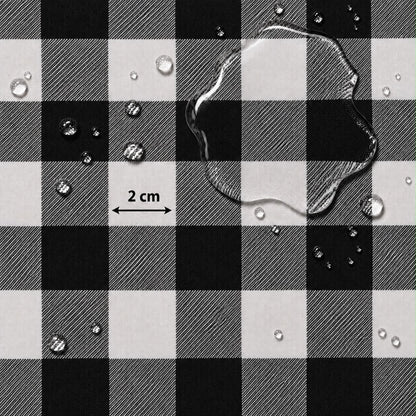 Black and white buffalo plaid fabric with water droplets on a white background and a '2 cm' scale marker.