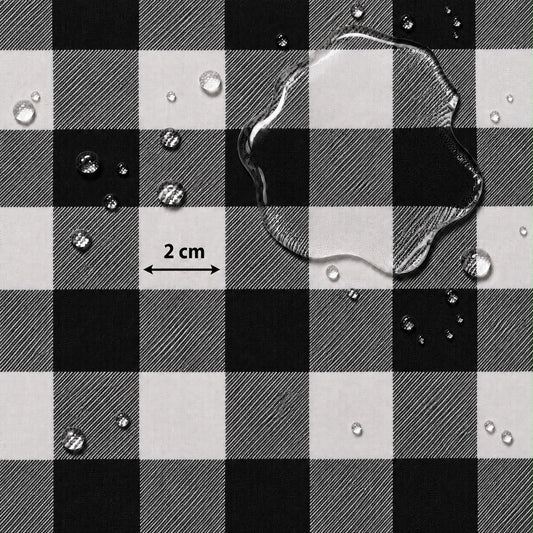 Black and white buffalo plaid fabric with water droplets on a white background and a '2 cm' scale marker.