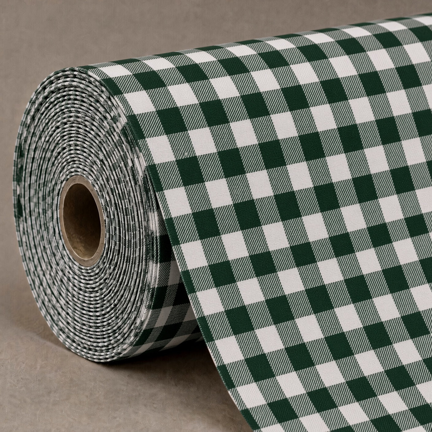 A roll of green and white gingham patterned wrapping paper or fabric, partially unrolled to show the checkered design and thin textured edge, set against a neutral gray background.