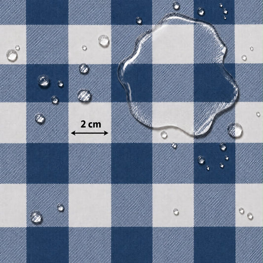 Blue and white checkered fabric surface with water droplets and a clear puddle on top, plus a small '2 cm' scale marker.