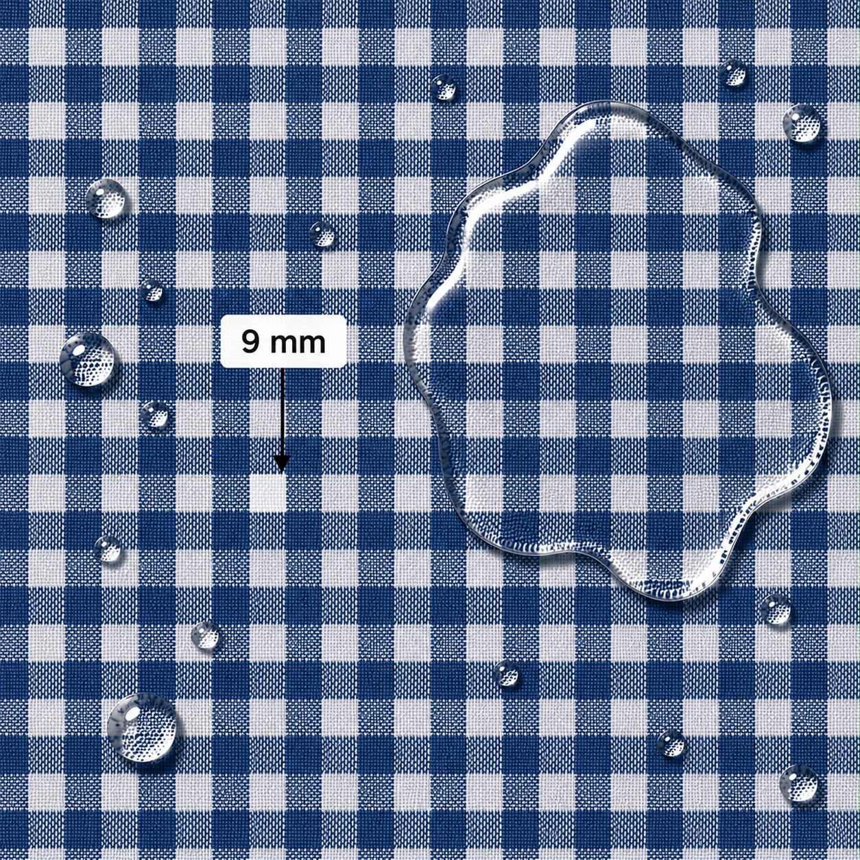 Blue and white gingham fabric surface with water droplets and a large clear water puddle, plus a label reading 9 mm indicating square width for scale.