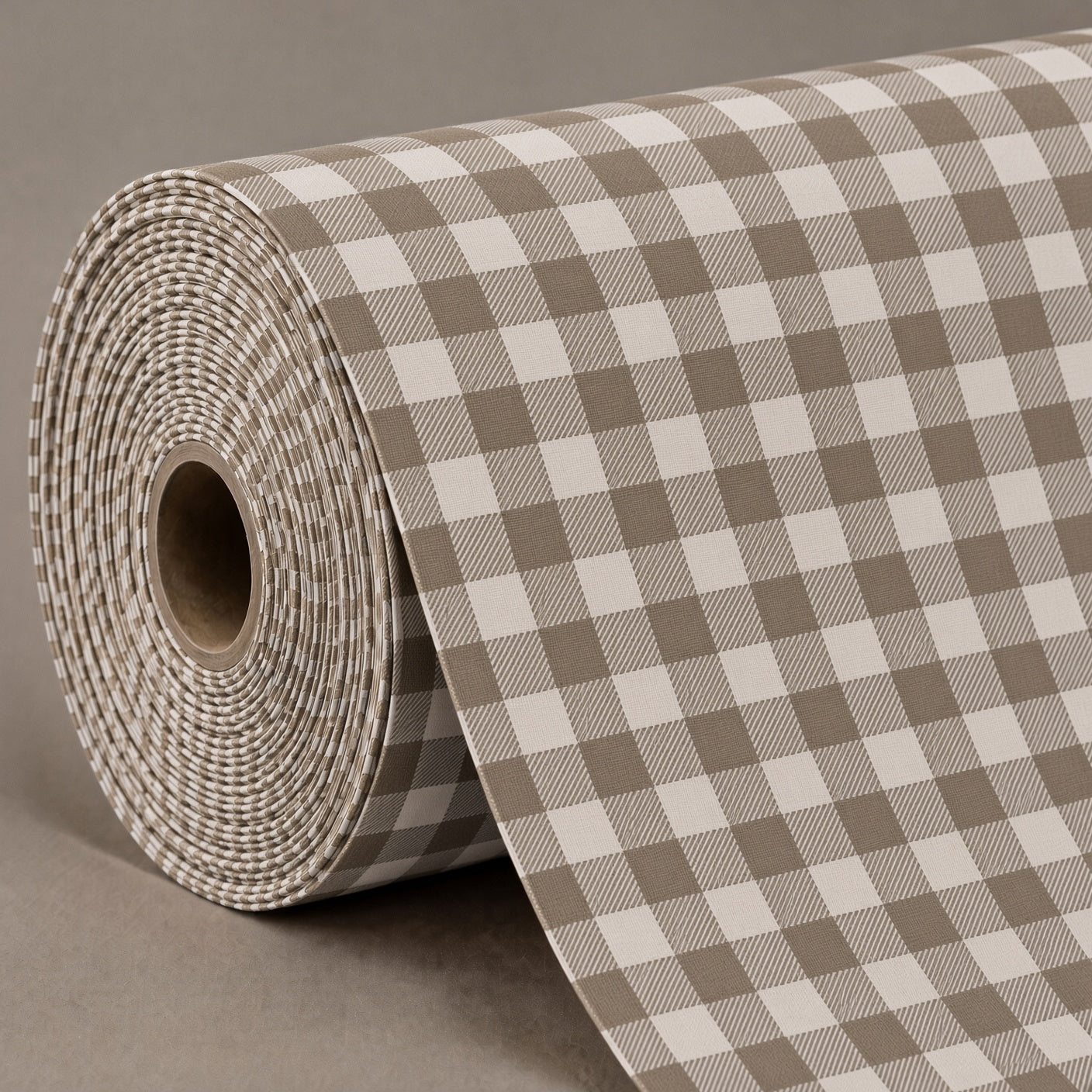 A roll of gingham checkered wrapping paper in taupe and off-white, shown partially unrolled on a neutral gray background.