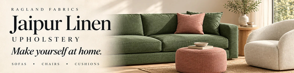 Jaipur Linen upholstery inspiration with a green sofa, ivory chair and clay accents