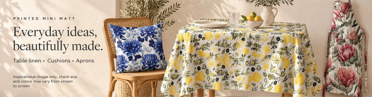 Printed Mini Matt fabric ideas: Lemon & Olive White tablecloth, Blue Delft cushion and Fynbos apron. Inspirational image; size and colour may vary.