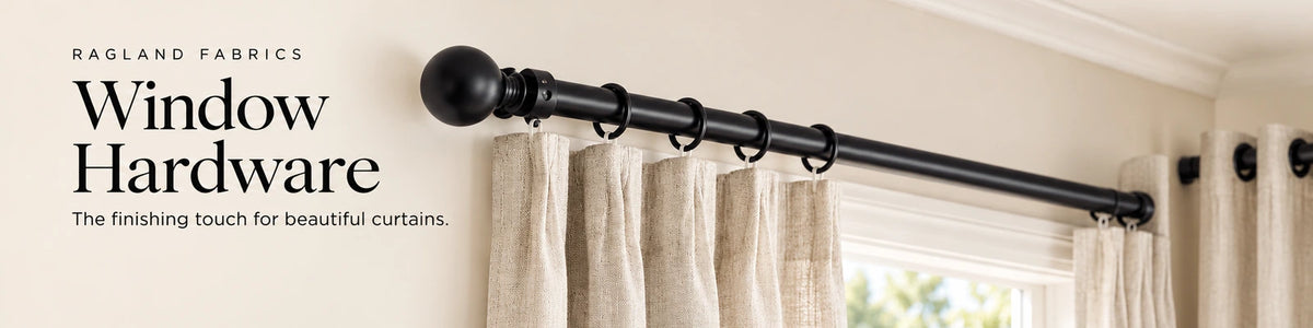Window Hardware: black curtain rods, ball finials and rings supporting linen curtains